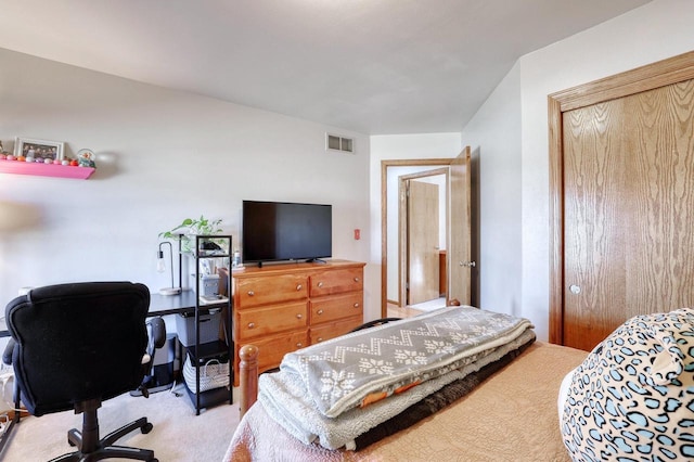 bedroom featuring a closet, visible vents, and carpet