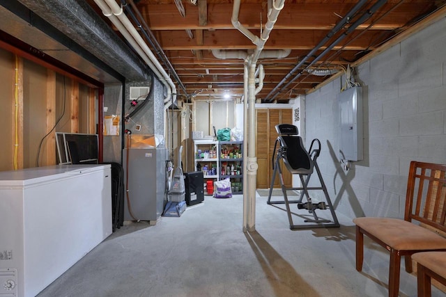 unfinished basement featuring electric panel and refrigerator