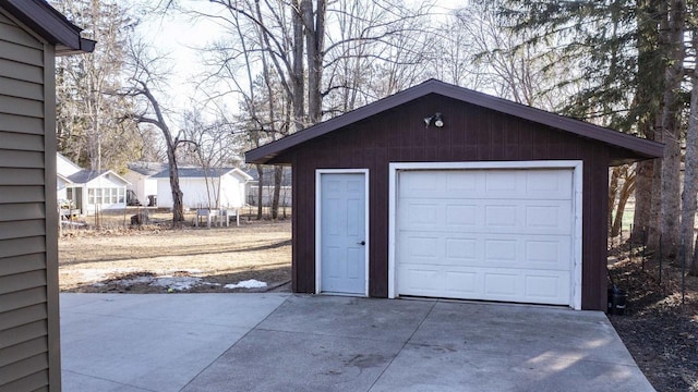 detached garage featuring driveway