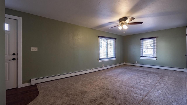 unfurnished room with a baseboard heating unit, a ceiling fan, and baseboards