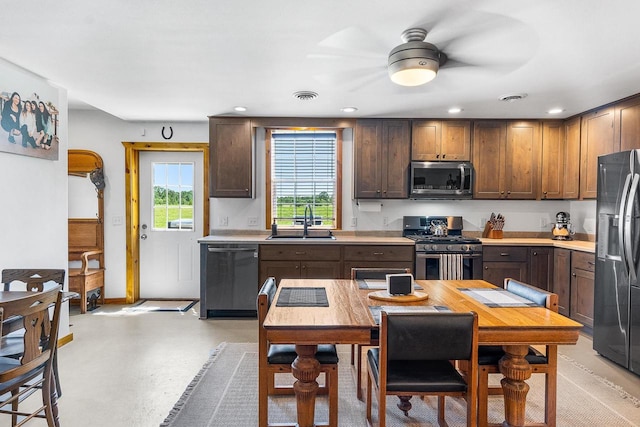 kitchen with light countertops, visible vents, appliances with stainless steel finishes, and a sink