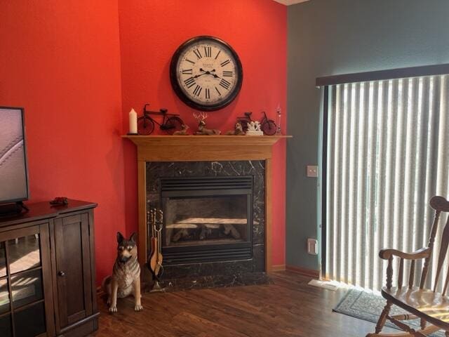 sitting room with a fireplace and wood finished floors