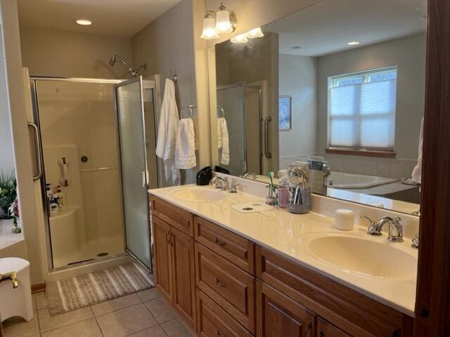 full bath with tile patterned floors, a shower stall, a bath, and a sink