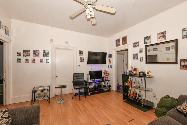 living room featuring light wood-type flooring and ceiling fan