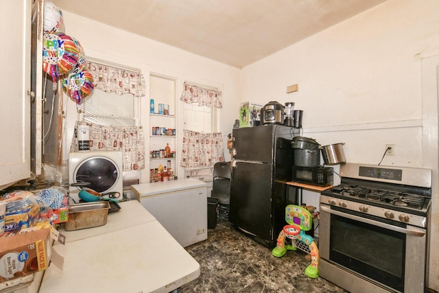 kitchen with washer / clothes dryer, black appliances, and light countertops