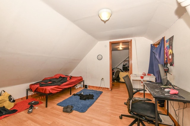 home office featuring vaulted ceiling and wood finished floors