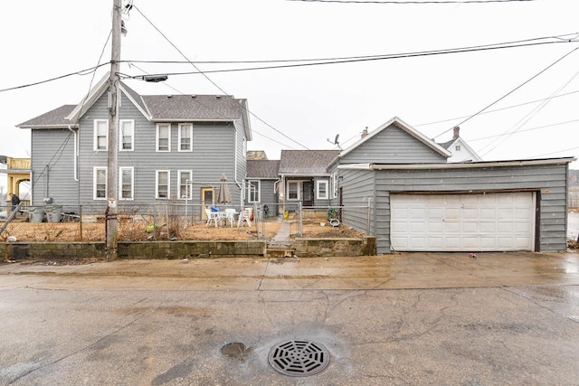 view of front facade with a garage and fence