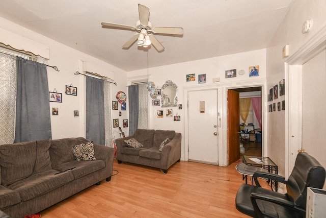 living area featuring a ceiling fan and light wood-type flooring