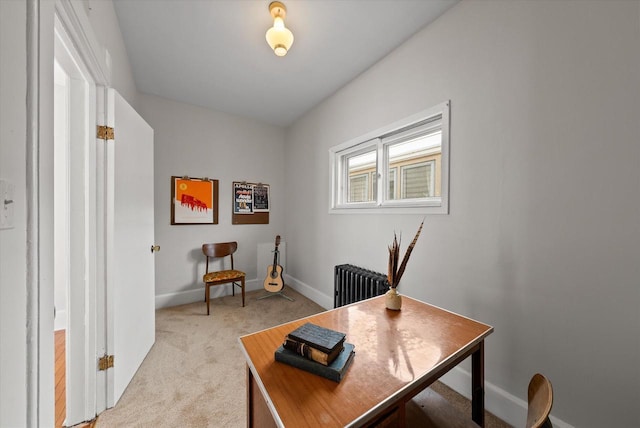 office space with baseboards, light colored carpet, and radiator heating unit