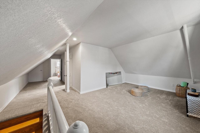 bonus room with vaulted ceiling, baseboards, carpet floors, and a textured ceiling