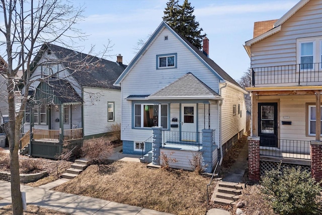 view of front facade featuring a porch and a shingled roof