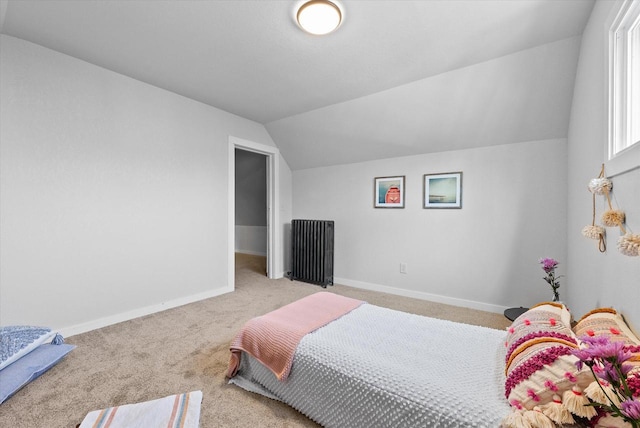 bedroom with baseboards, carpet, lofted ceiling, and radiator heating unit