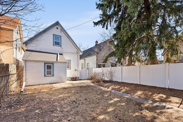 back of house featuring a fenced backyard