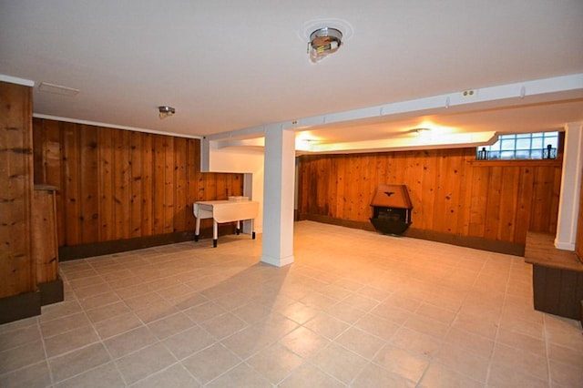 basement featuring wooden walls