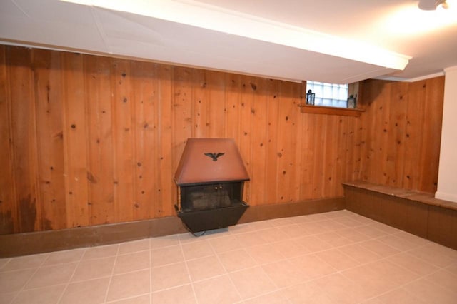 basement with wood walls and tile patterned flooring