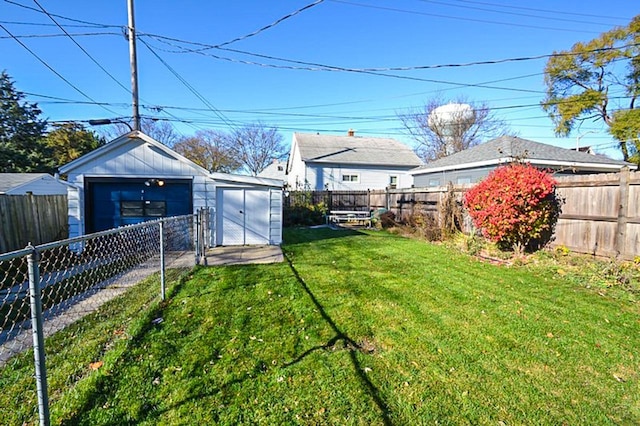 view of yard with an outbuilding, a fenced backyard, and a shed