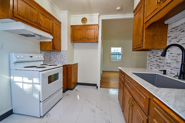 kitchen with under cabinet range hood, brown cabinets, electric stove, marble finish floor, and a sink