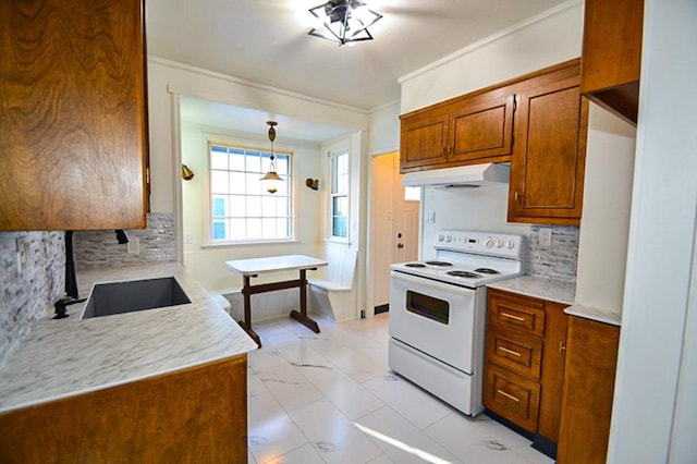 kitchen with white electric range oven, light countertops, brown cabinets, and under cabinet range hood