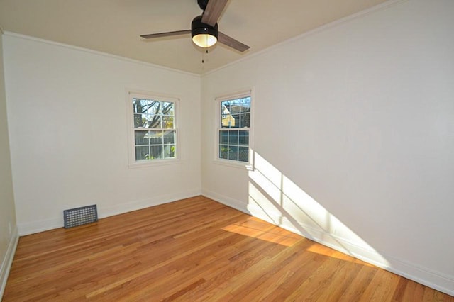 unfurnished room with baseboards, light wood-style flooring, a ceiling fan, and ornamental molding