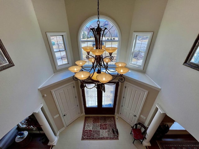 foyer with a notable chandelier and a towering ceiling