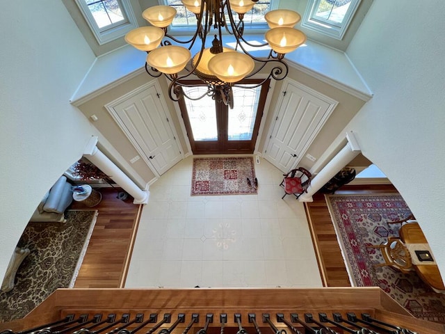 entryway with a wealth of natural light, a skylight, and a high ceiling