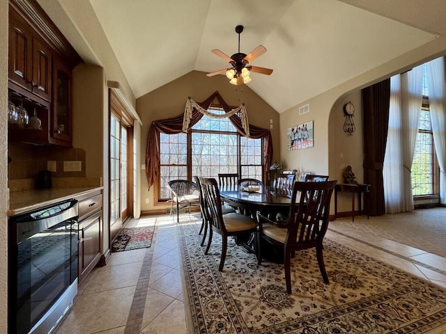 dining area featuring visible vents, baseboards, beverage cooler, lofted ceiling, and a ceiling fan