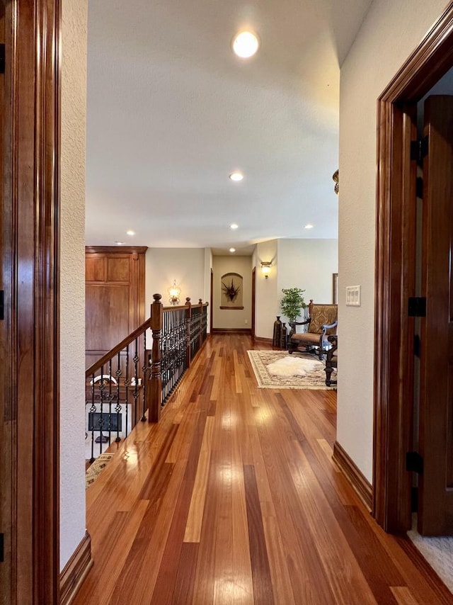 corridor with recessed lighting, baseboards, and wood-type flooring