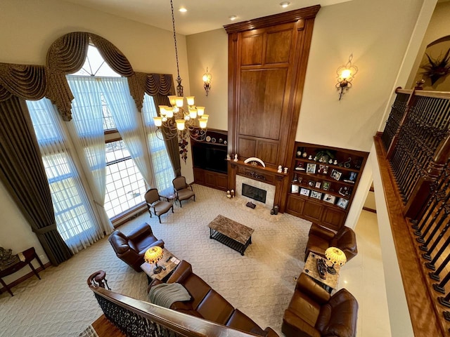 carpeted living area with stairs, an inviting chandelier, and a premium fireplace