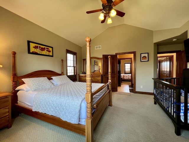 bedroom featuring visible vents, baseboards, lofted ceiling, ceiling fan, and light colored carpet