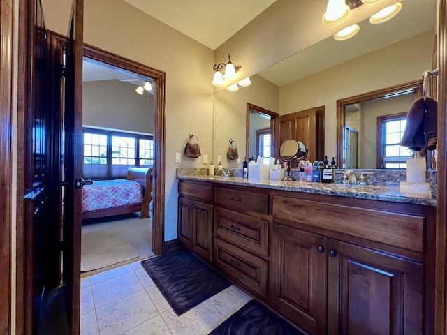 ensuite bathroom with double vanity, ensuite bath, a sink, tile patterned flooring, and an enclosed shower