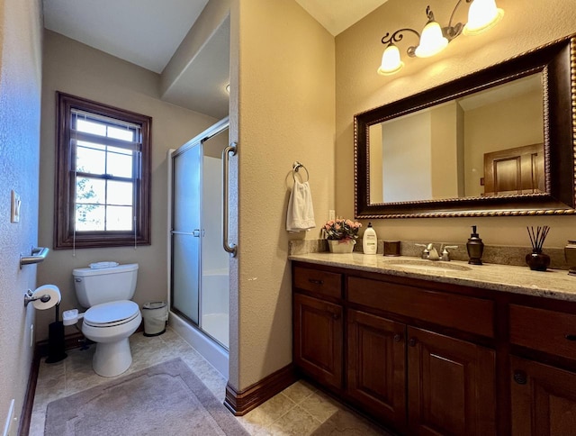 full bathroom featuring a stall shower, toilet, vanity, and baseboards