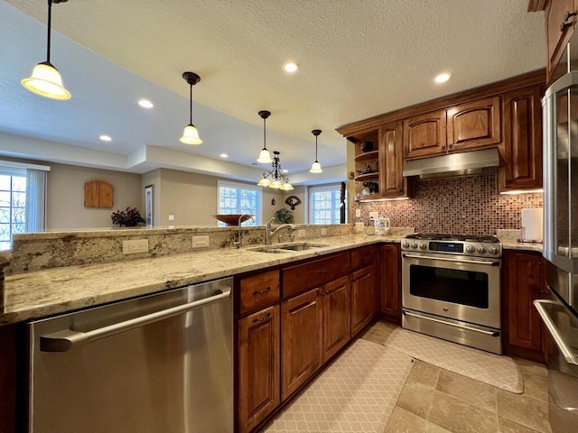 kitchen featuring under cabinet range hood, open shelves, a sink, appliances with stainless steel finishes, and light stone countertops