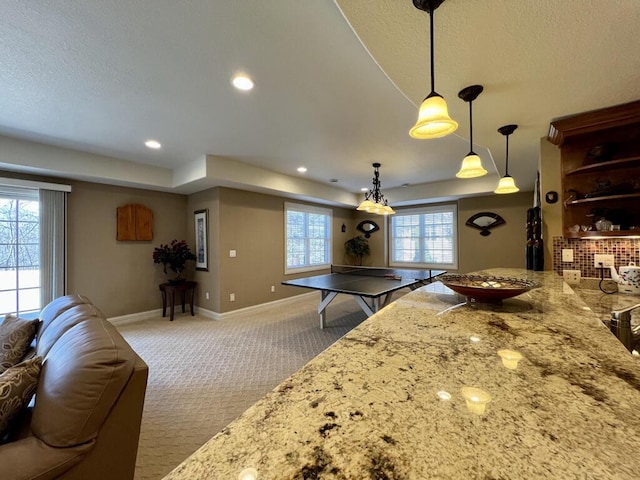 kitchen with light stone countertops, baseboards, carpet floors, open shelves, and recessed lighting