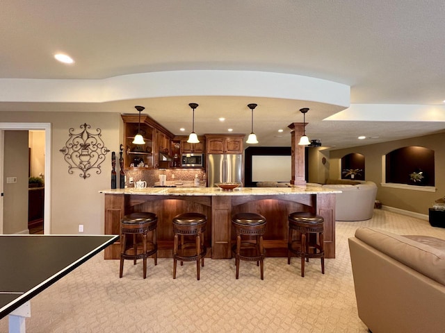 bar with wet bar, backsplash, recessed lighting, and appliances with stainless steel finishes