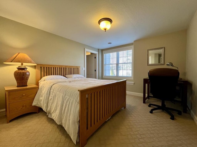 bedroom featuring baseboards and light carpet