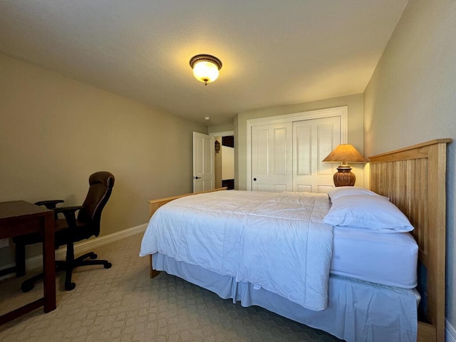 bedroom featuring a closet, baseboards, and carpet floors