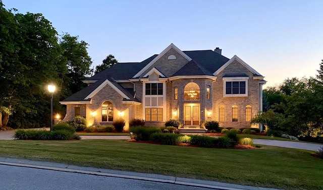 view of front of home featuring a chimney and a front yard