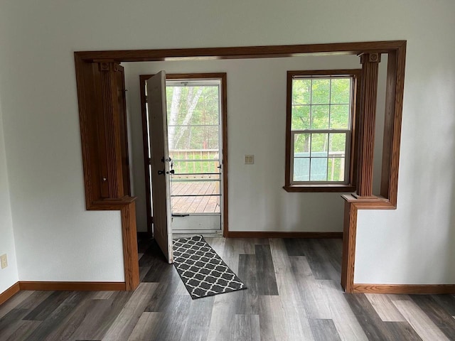 entryway with baseboards and wood finished floors