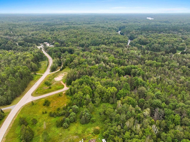 birds eye view of property featuring a wooded view