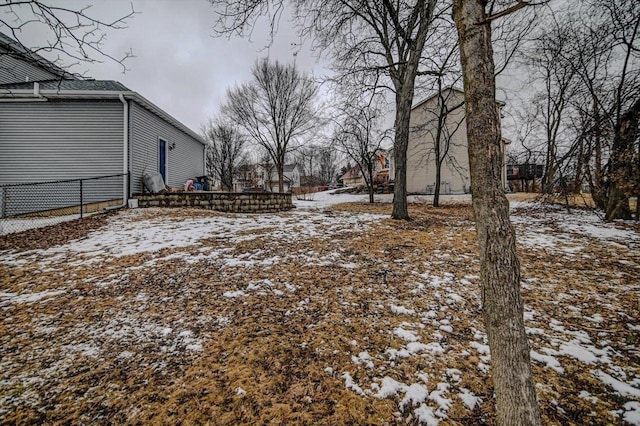 yard covered in snow featuring fence