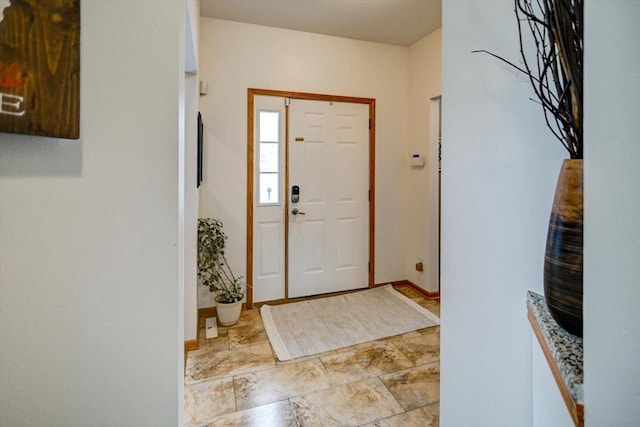 foyer entrance featuring baseboards