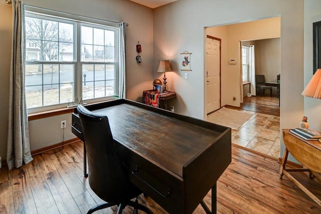 game room with light wood-style floors, baseboards, and a healthy amount of sunlight