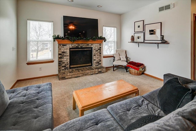 carpeted living room featuring visible vents, baseboards, and a brick fireplace