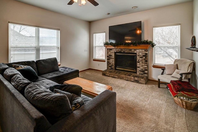 living room featuring a ceiling fan, a fireplace, baseboards, and carpet floors