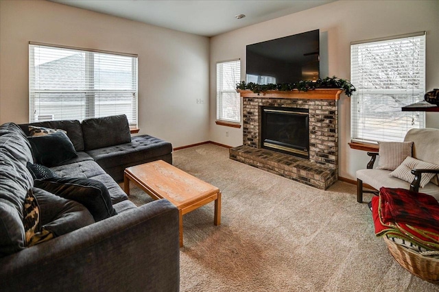 carpeted living room featuring baseboards and a fireplace