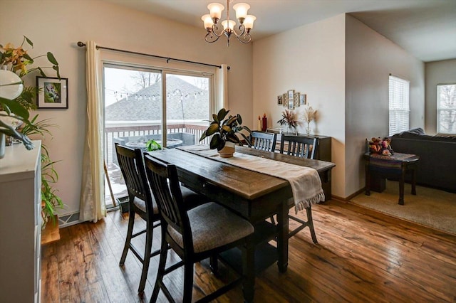 dining room featuring an inviting chandelier, hardwood / wood-style flooring, and plenty of natural light