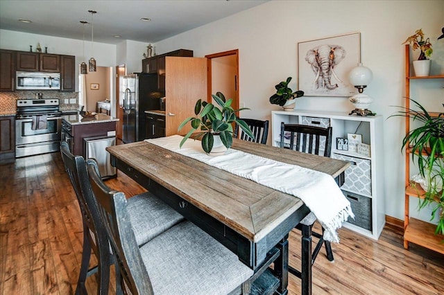 dining area with wood finished floors