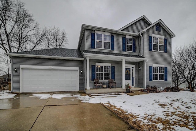 traditional-style house featuring a porch, an attached garage, and concrete driveway