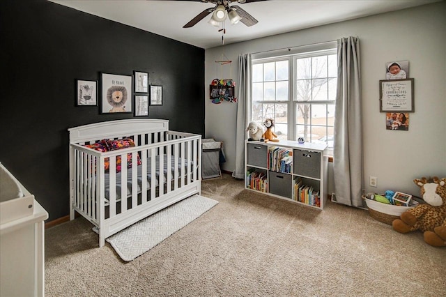 bedroom featuring carpet flooring, ceiling fan, baseboards, and a nursery area