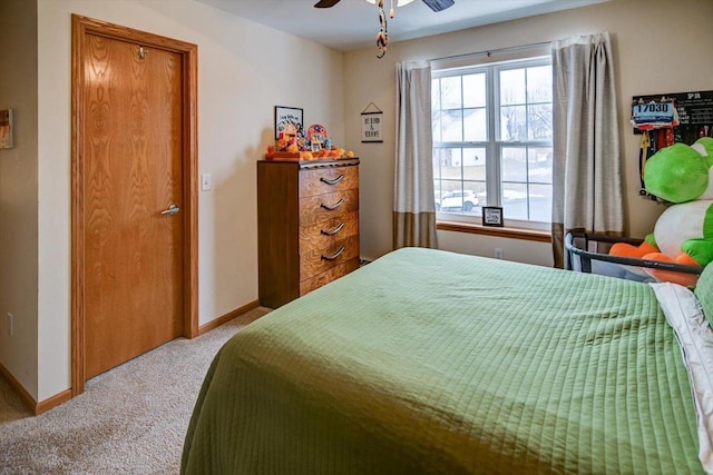 bedroom featuring baseboards, carpet floors, and ceiling fan